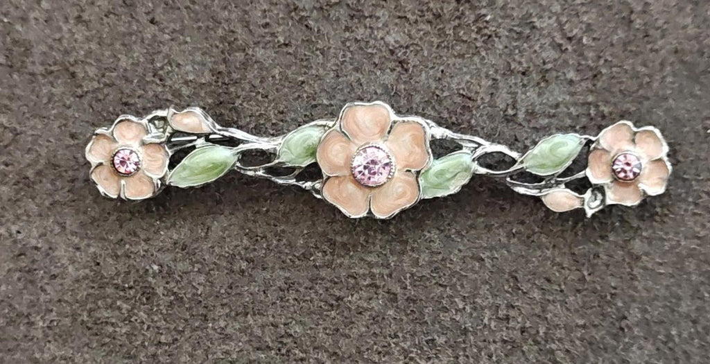 Floral bar brooch side view, green enamel leaves with pink round stone highlights