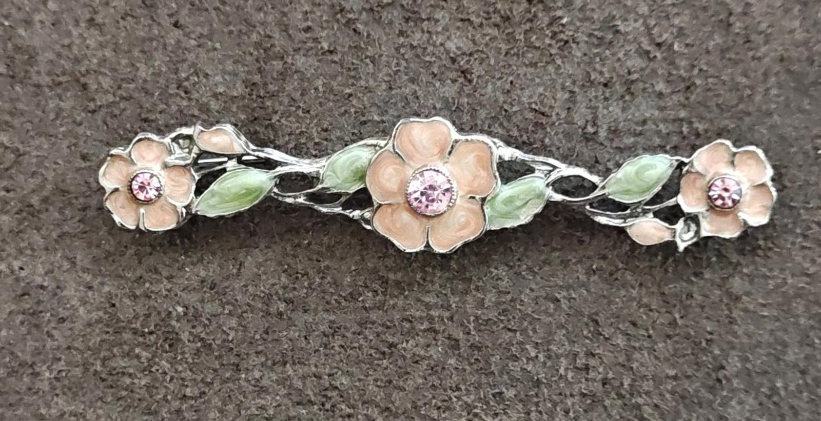 Floral bar brooch side view, green enamel leaves with pink round stone highlights