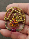 Gold-tone abstract beaded brooch with triangle beadwork and red cabochon center