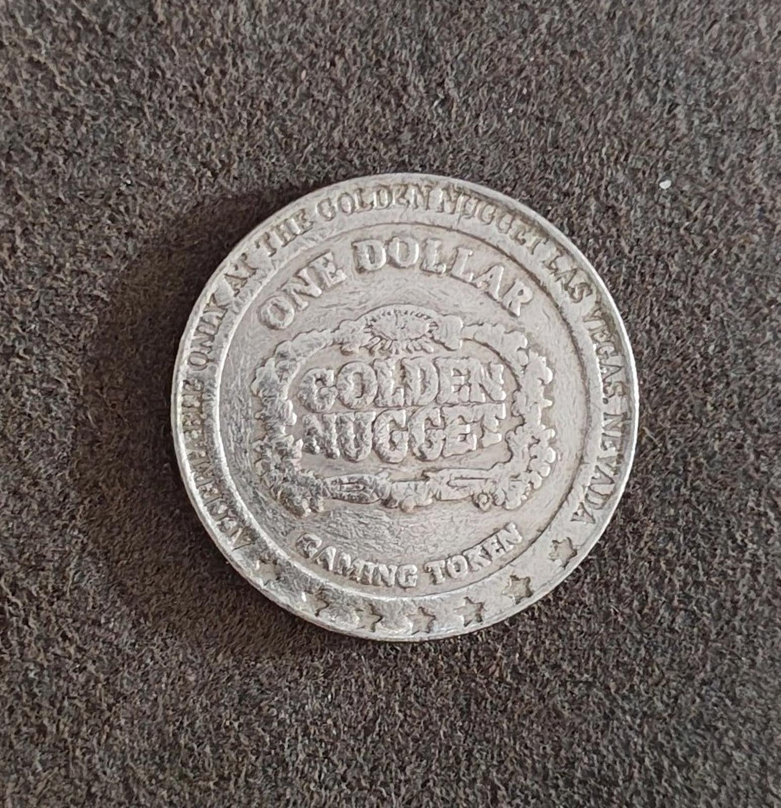 Silver Golden Nugget one-dollar token reverse, showing GOLDEN NUGGET and COMING TOKEN.