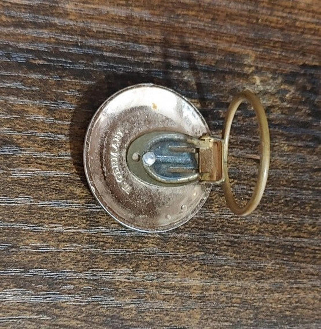 Scarf clip reverse with clasp pin, gold inner detail, and silver outer circle