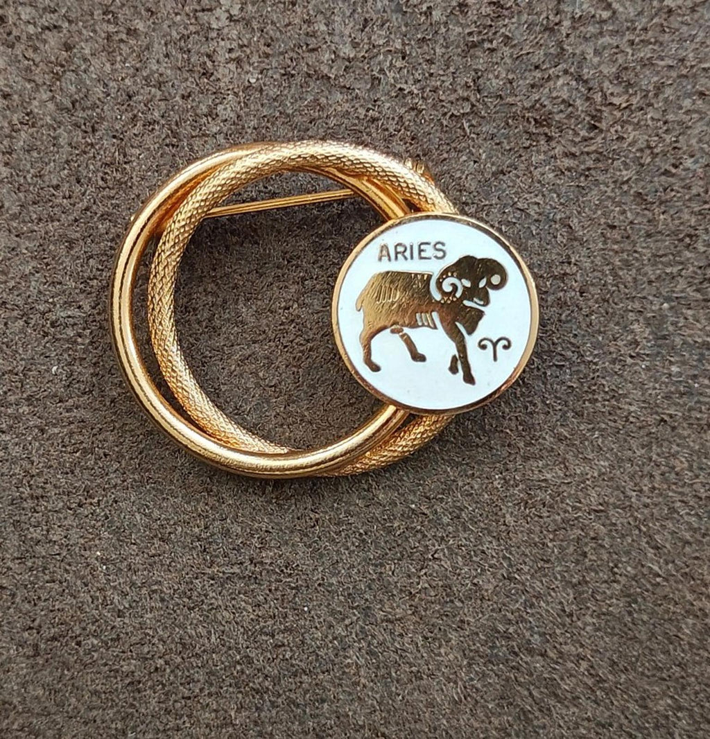 Gold tone double-circle Aries zodiac brooch pin with white enamel bull figure