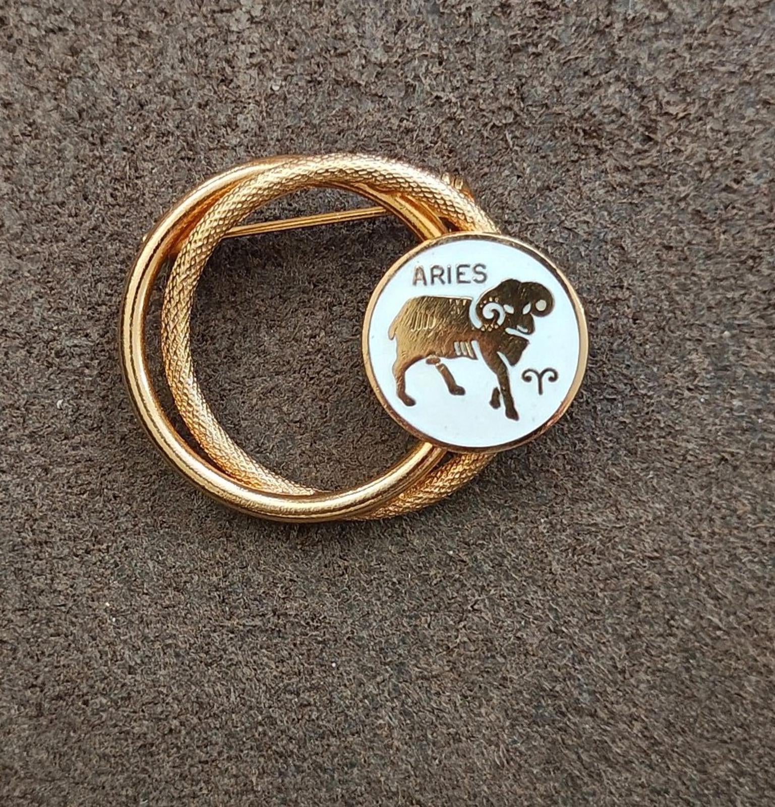 Gold tone double-circle Aries zodiac brooch pin with white enamel bull figure