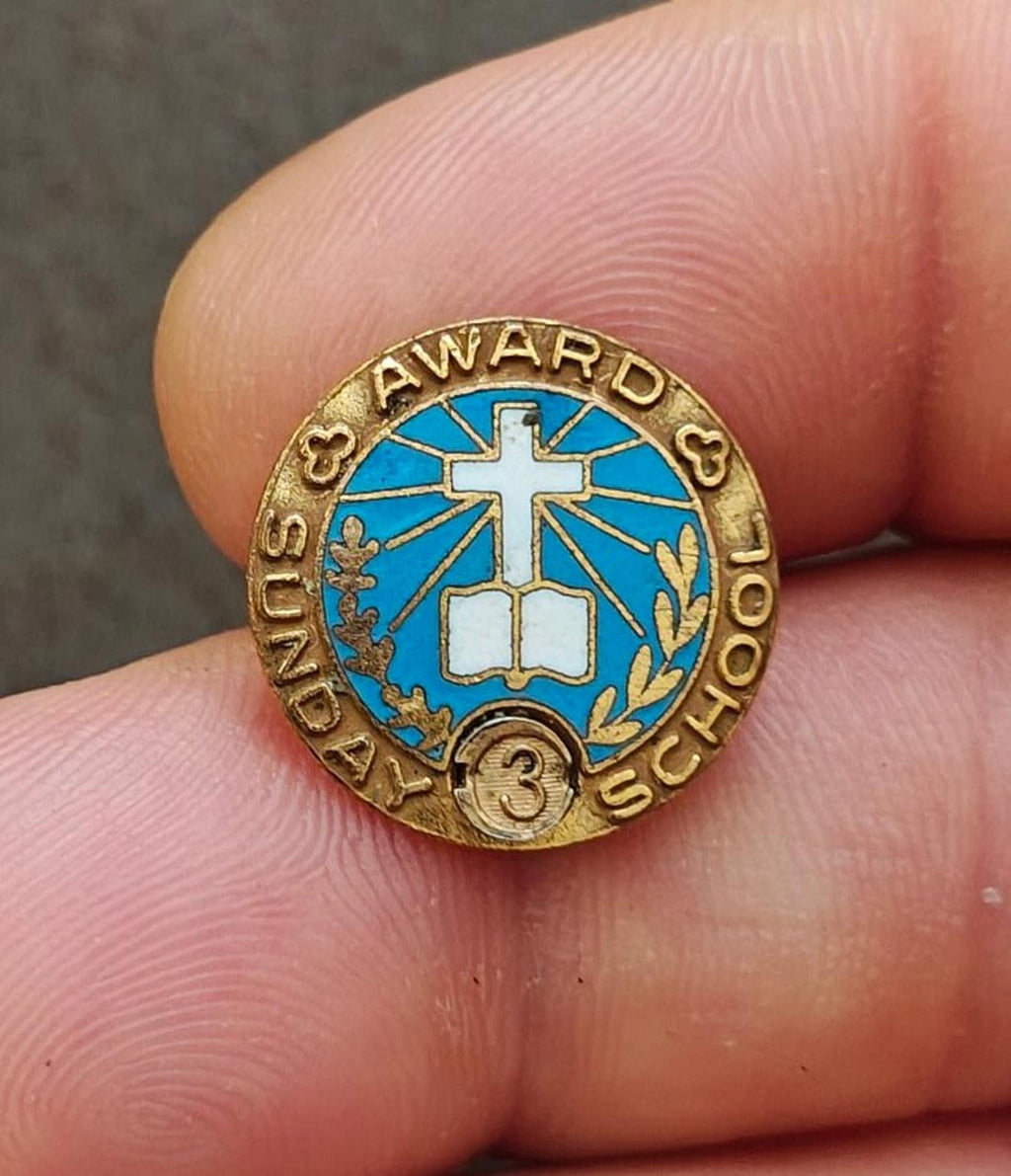 Vintage gold-tone Sunday School attendance award pin with blue enamel cross and "AWARD" ring