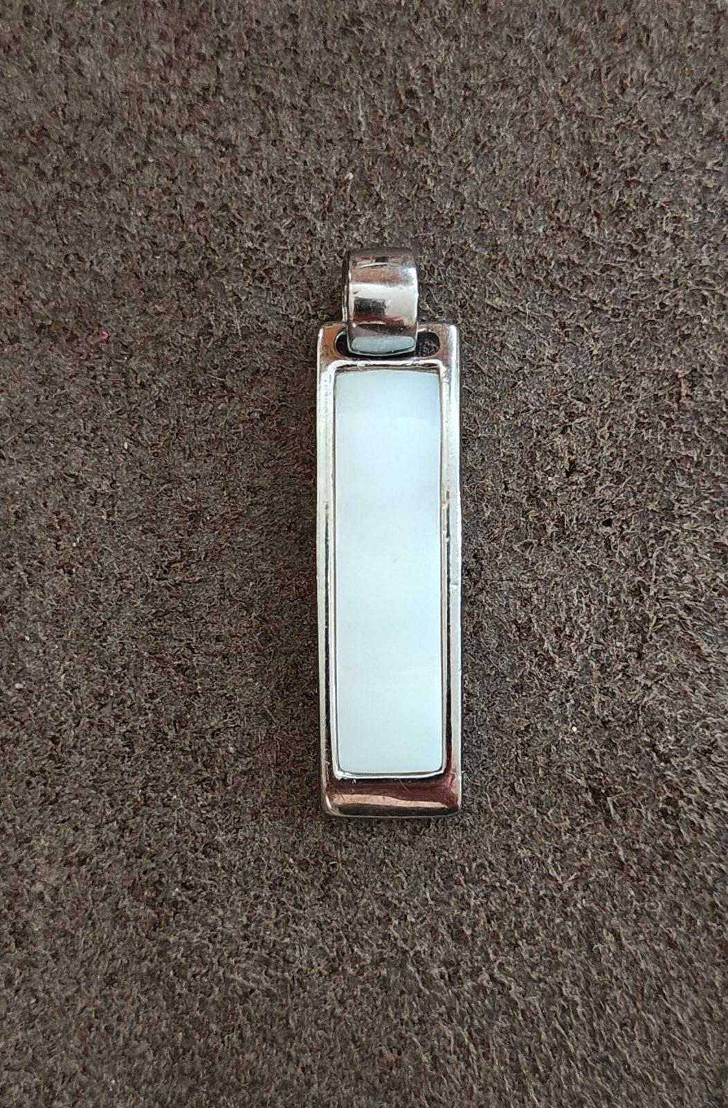 Silver-tone rectangular slide pendant, light inlay front view with bail at top.