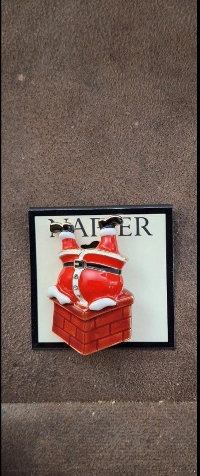 Red Santa climbing down chimney enamel pin on card, small centered view