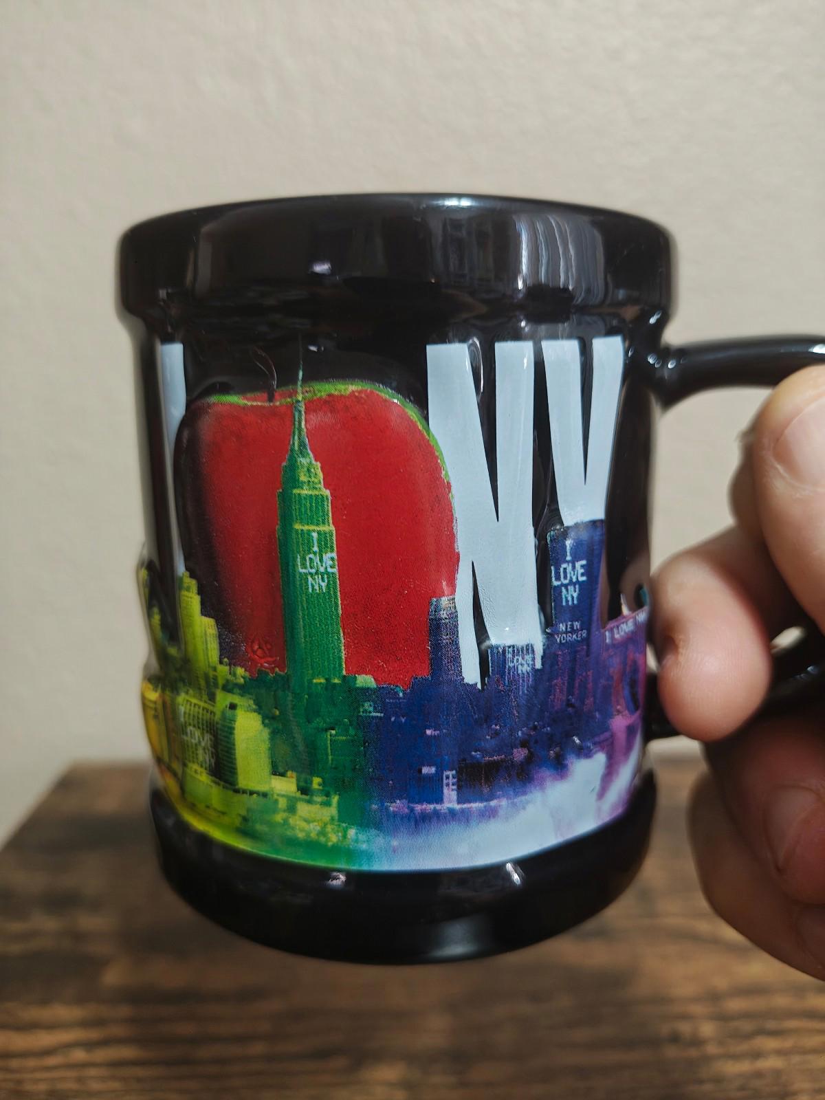 Black ceramic mug with colorful skyline graphic wraparound, glossy finish, right-side view