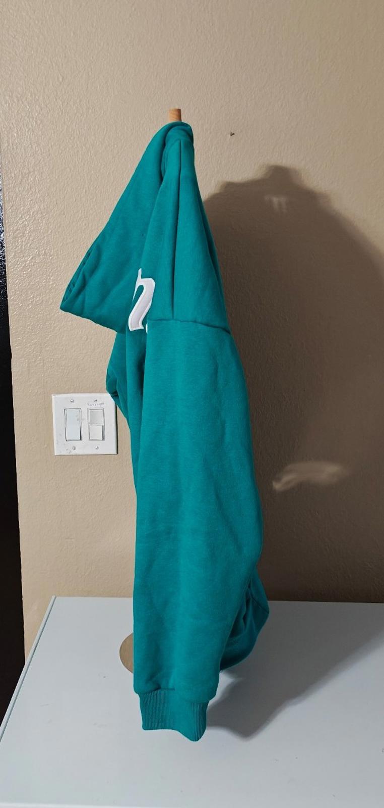 Teal hooded zip-up hoodie shown from the back/side