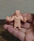 Pink bathrobe plastic wrestling mini figure with raised arms and smiling face