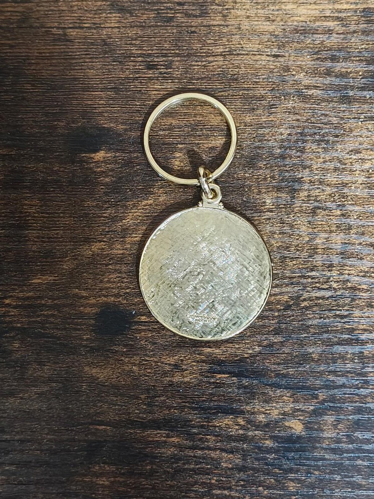 Round keychain back with gold ring and plain shiny metal enamel finish