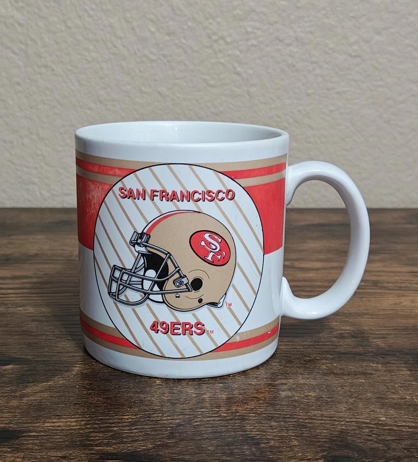 San Francisco 49ers helmet logo mug with red stripes and white handle.