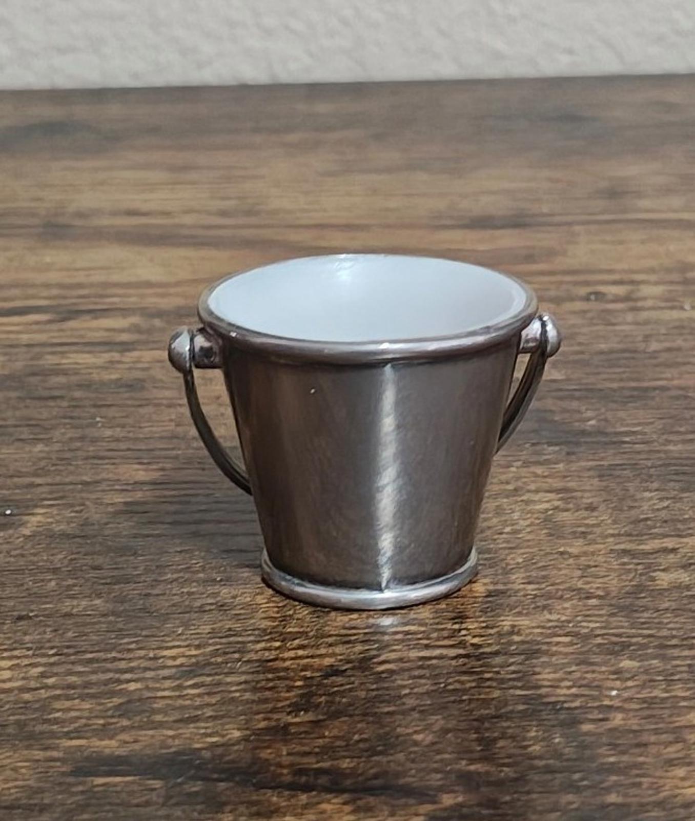 Mini silverplated bucket pail with two loop handles and white interior