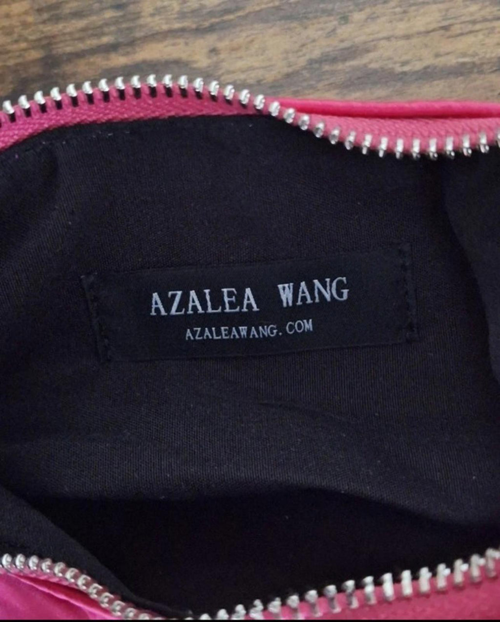 Inside view of black lining with AZALEA WANG label and pink zipper trim