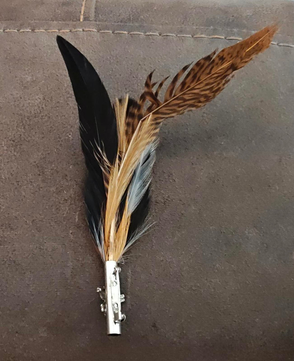 Feather hat brooch with dark and gold-toned feathers and silver-tone pin clasp