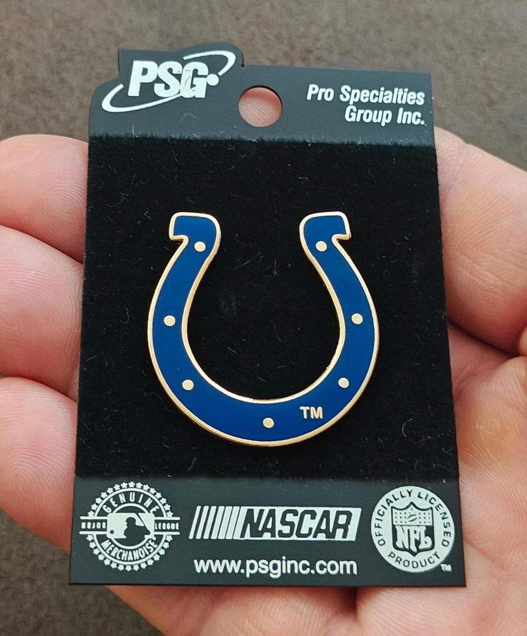 Front horseshoe enamel pin with blue enamel and gold border on PSG card
