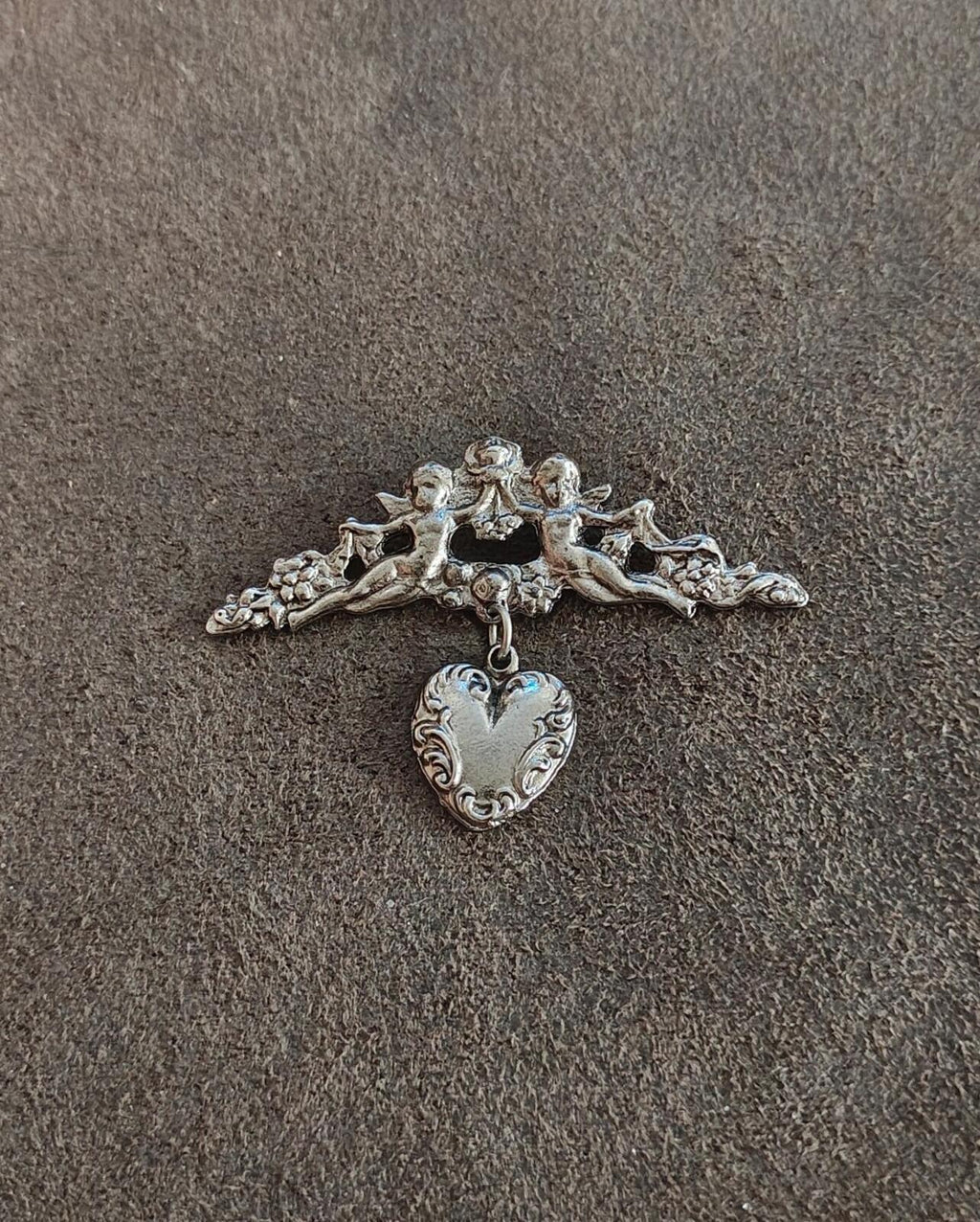 1980s Silver Tone Renaissance Style Cherub Brooch With Dangling Heart Charm