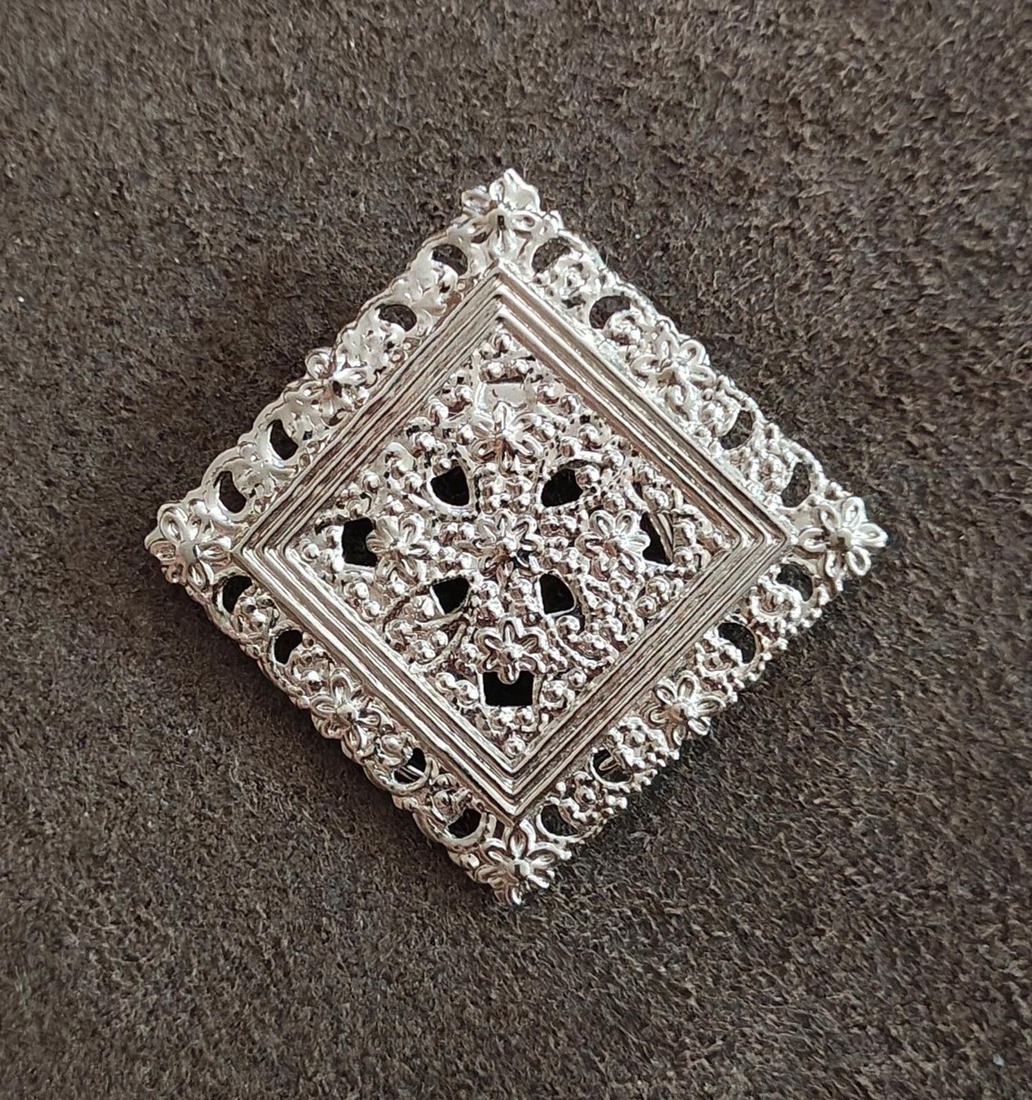 Silver-tone square open filigree scarf clip with floral cutout motif and scroll edging