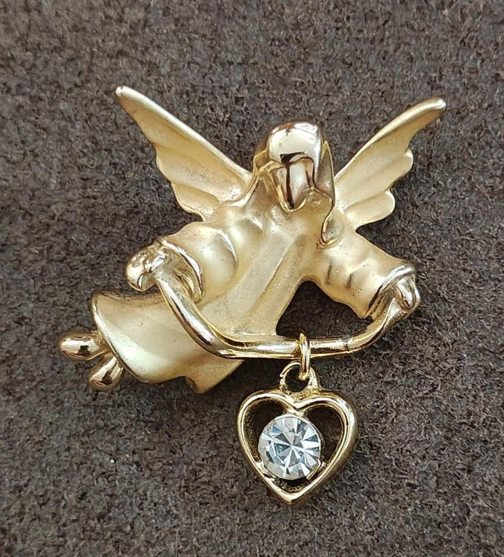 Gold-tone angel brooch pin with hanging heart charm and round faceted crystal