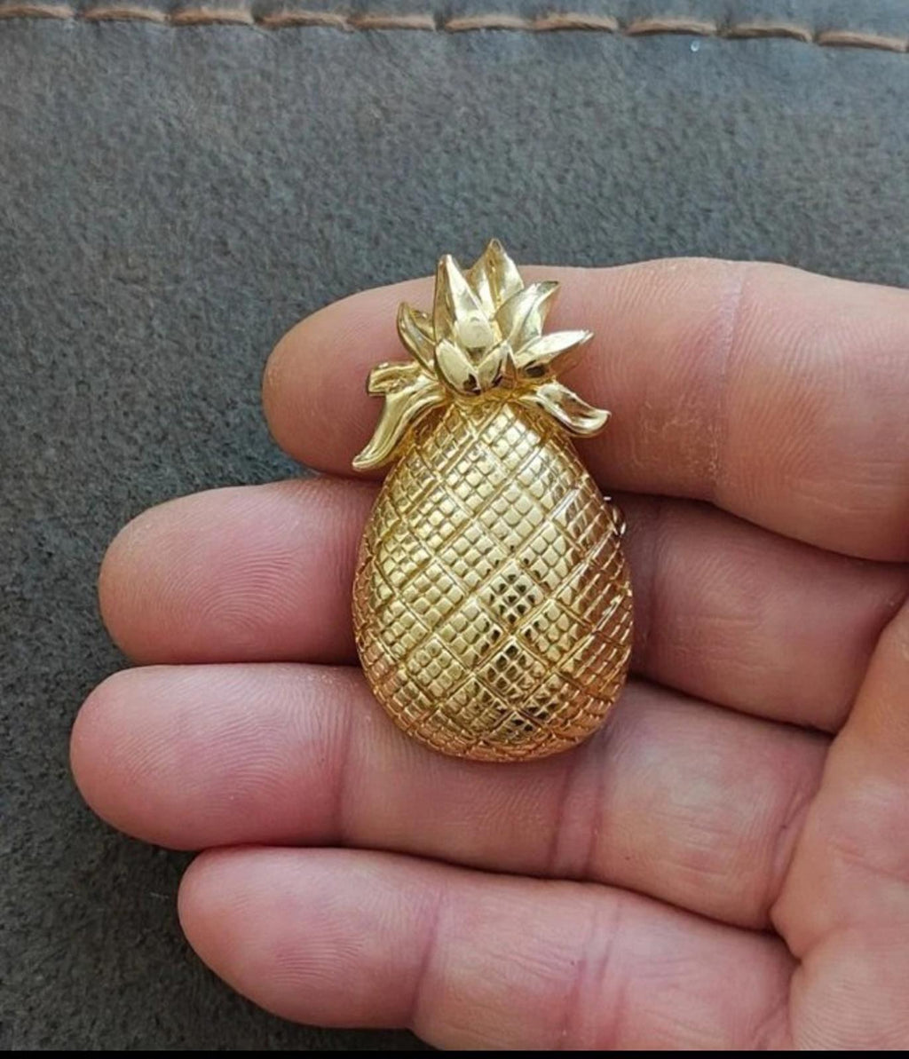 Gold tone pineapple brooch pendant with glittery texture and leaf cluster top